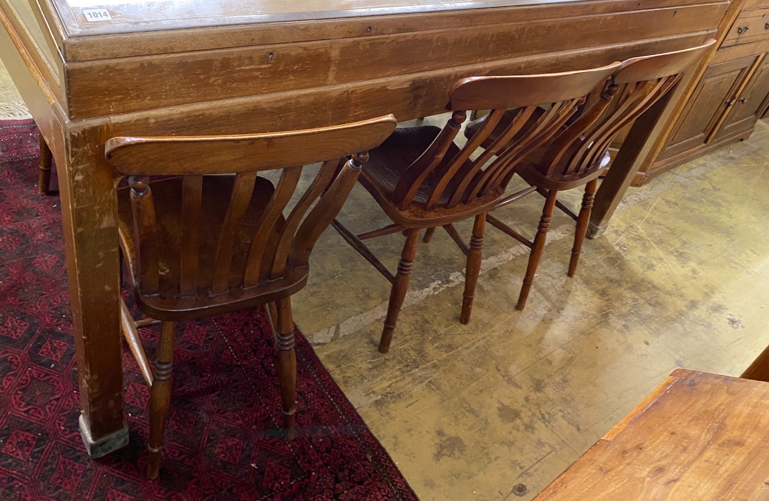 A set of six Victorian elm and beech Windsor lathe back kitchen chairs together with a circular part painted elm stool